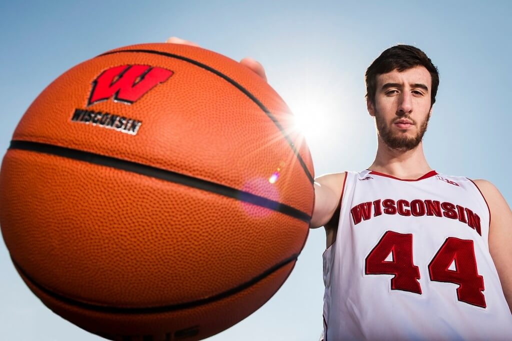 Big basketball, big accomplishments: Frank Kaminsky, who swept multiple national player honors, including the prestigious John R. Wooden Award, poses with one of the tools of his trade.
