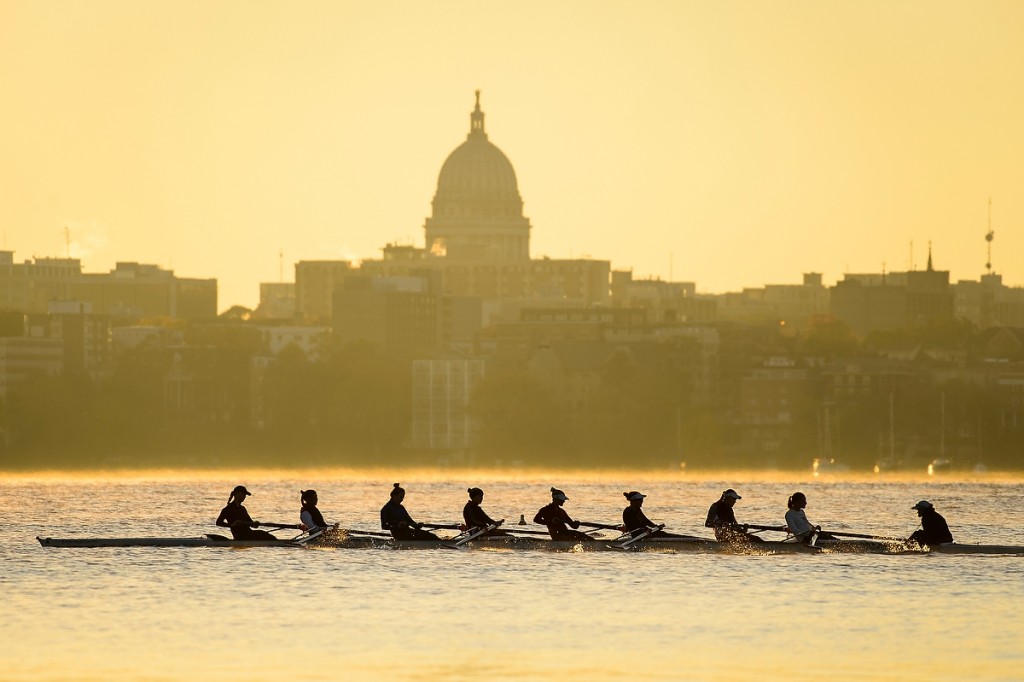 This is the reward for getting up before dawn: a view of women's crew rowing along Lake Mendota with the downtown Madison skyline as the backdrop.