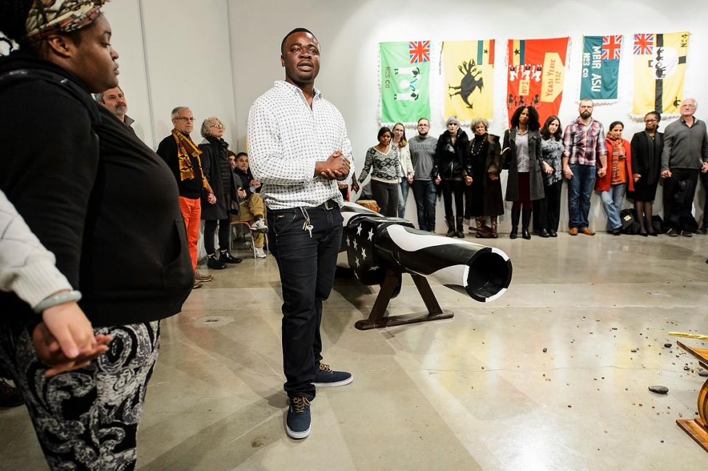 As a symbol against gun violence, artist in residence Eric Adjetey Anang invites guests to help break the barrel of the gun-shaped coffin that he created at the Art Lofts.