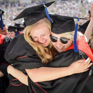 Two graduates share their emotions at the conclusion of Saturday's ceremony at Camp Randall.