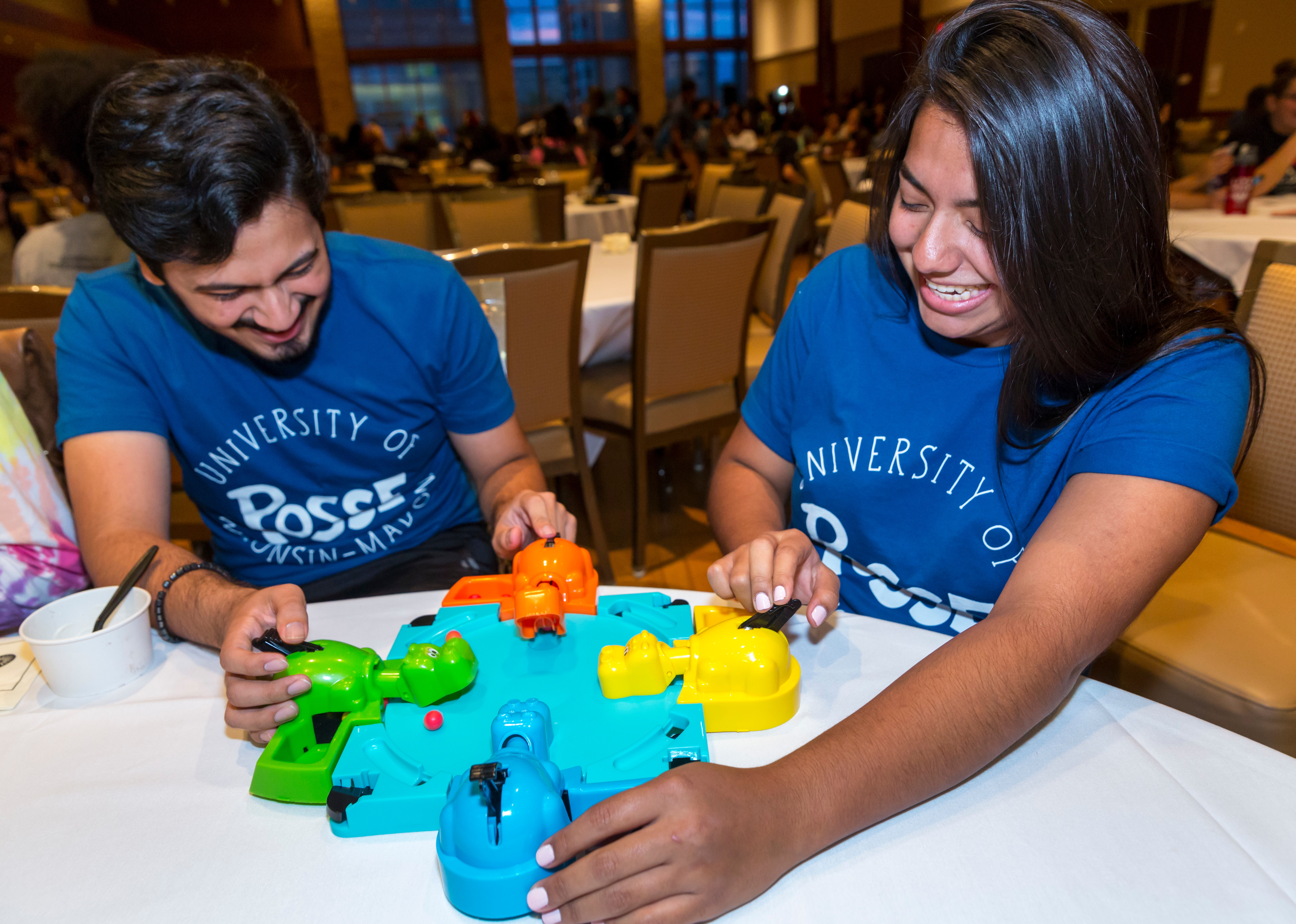 Syed Bukhari, and Kiana Gomez play a game of Hungry Hungry Hippos at the DDEEA Kick Back event.