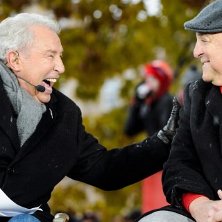 Photo of commentator Lee Corso speaking with Athletic Director Barry Alvarez.
