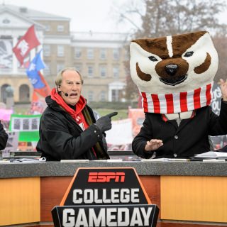 Photo of The day's celebrity guest, actor Craig T. Nelson, closing the broadcast with Corso clad as Bucky Badger.