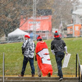 Photo of fan wrapped in a Wisconsin athletic flag