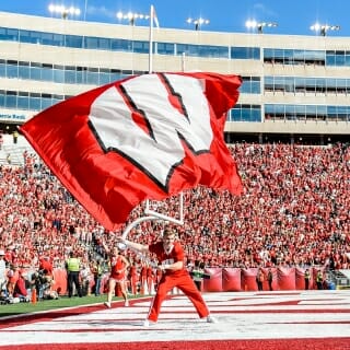 A member of the UW Spirit Squad waves a giant W flag after the Badgers score a touchdown during the UW Homecoming football games versus Maryland inside Camp Randall Stadium at the University of Wisconsin-Madison on Oct. 21, 2017. The Badgers won the game 38-13. (Photo by Bryce Richter / UW-Madison)