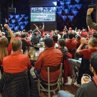 UW Badger fans gather together inside The Sett at Union South to watch the Big Ten Championship game between Wisconsin and Ohio State on Dec. 2, 2017. photo by bryce richter