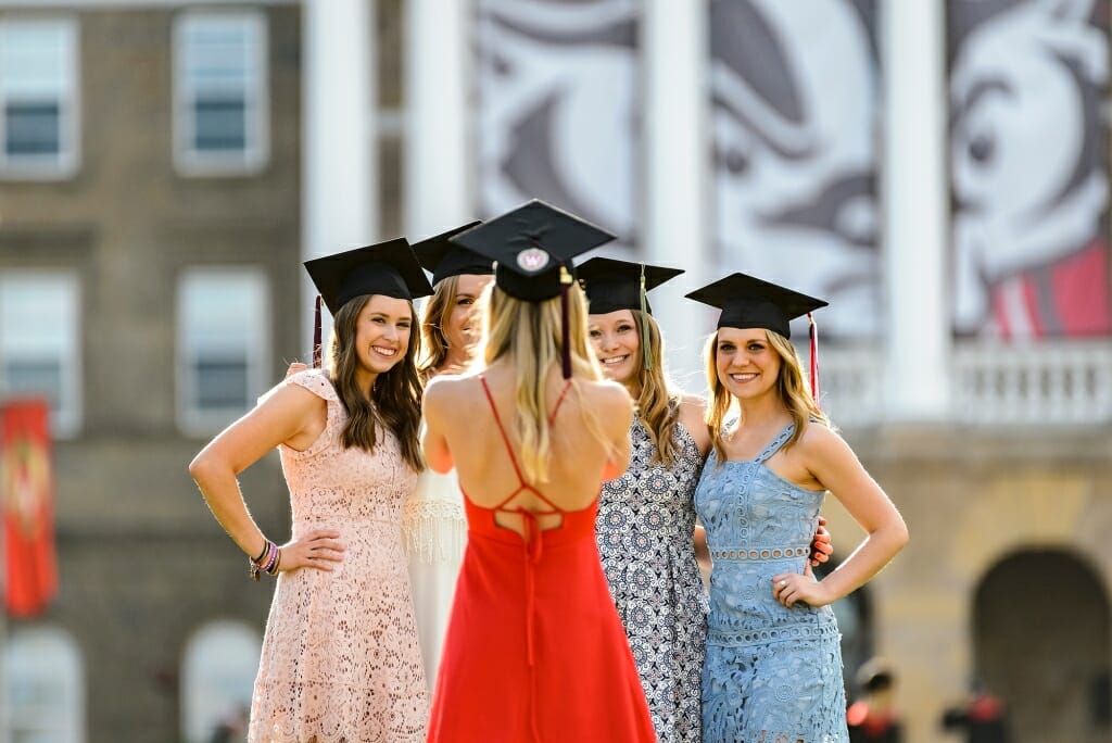 Graduates gather for a group shot in front of Bascom Hall.