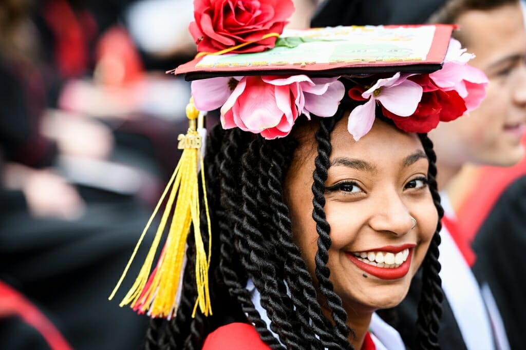Photo of Arissa Milton, graduating with bachelor's degrees in neurobiology and psychology, who decked her mortarboard in flowers.